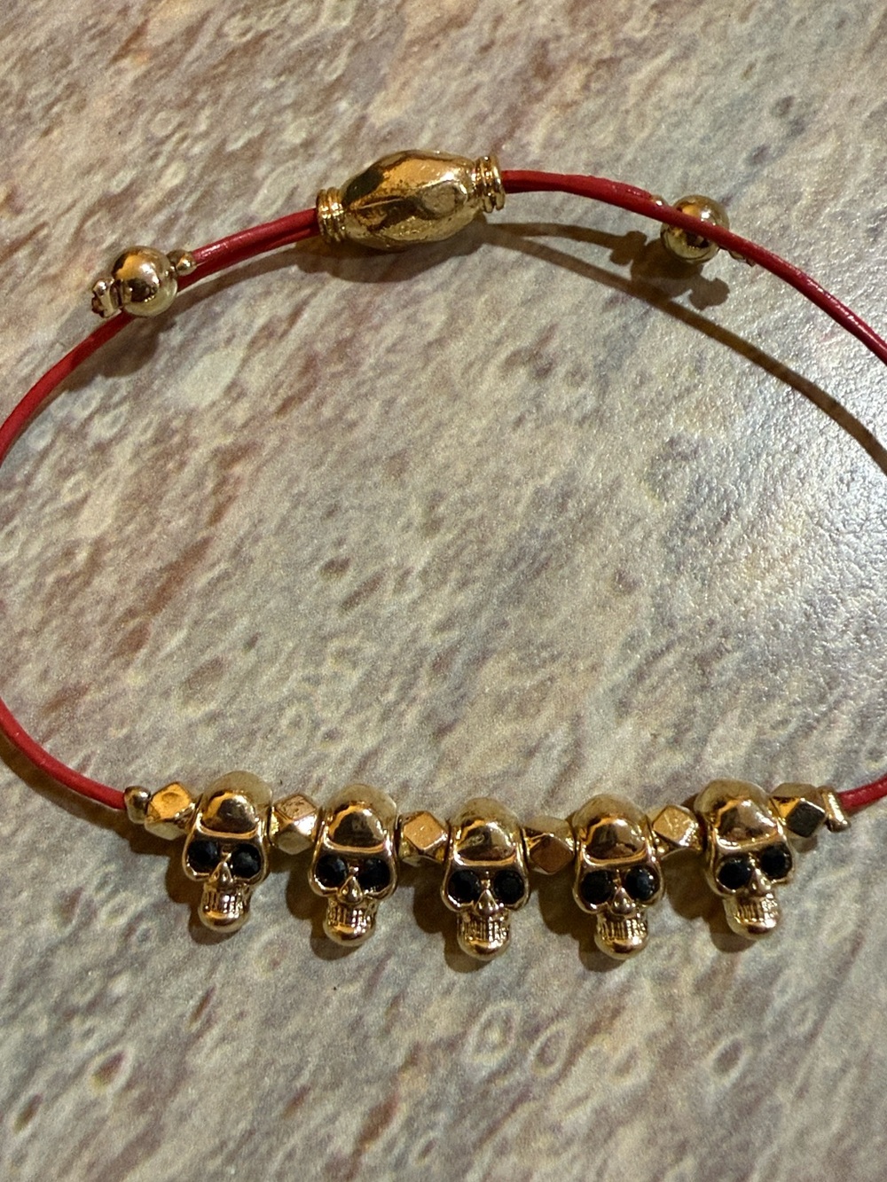 Gold-Tone Skull Bead Bracelet with Red Cord